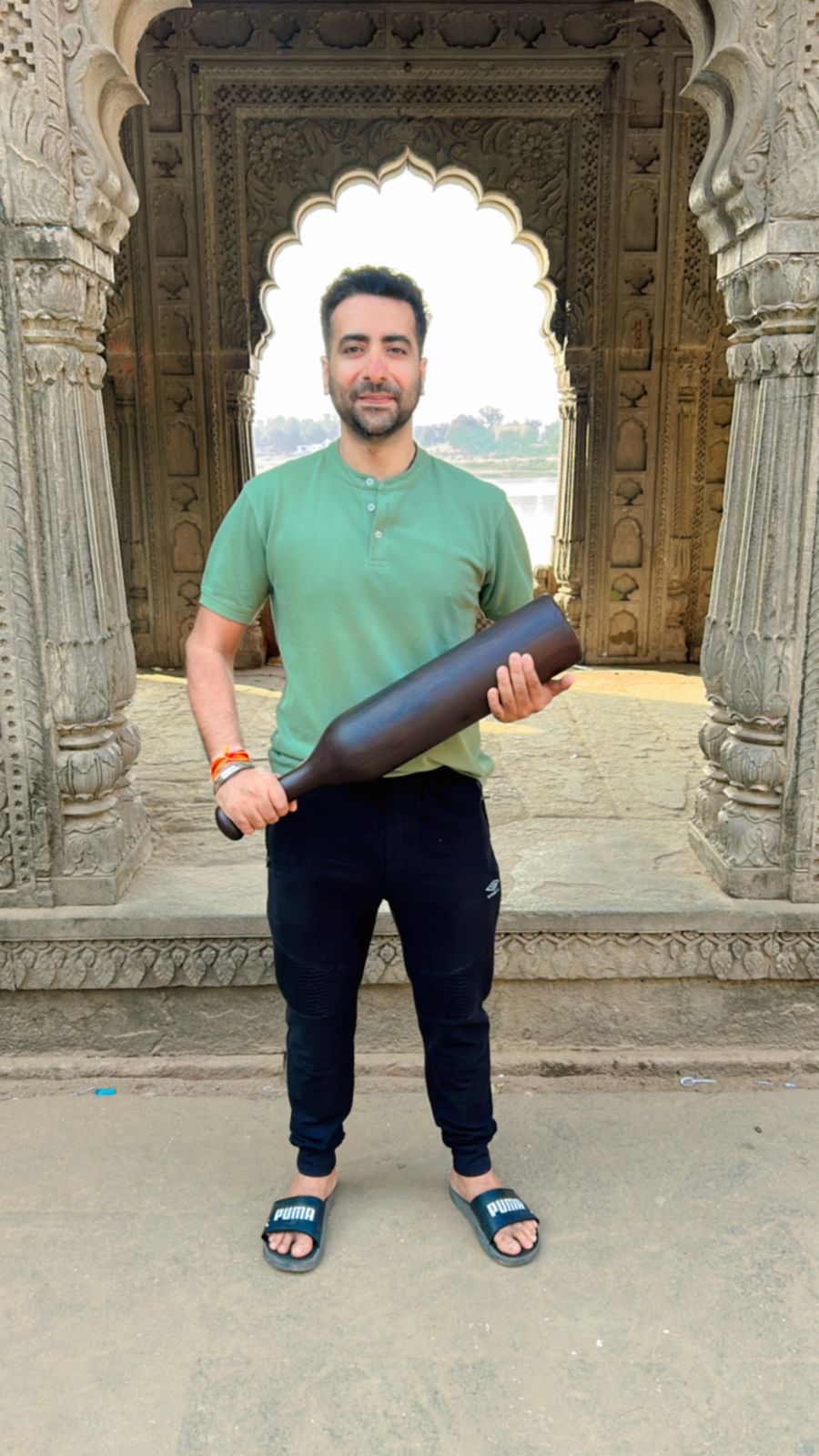 Coach Haresh holding a wooden Mudgar